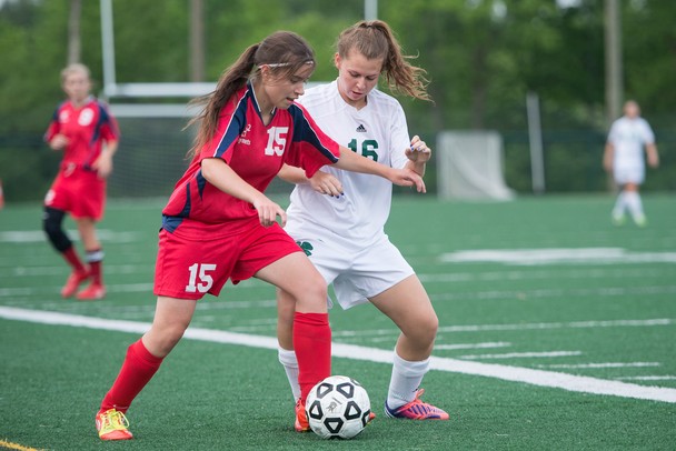 Father Gabriel Richard's Lilly Geppner and Hanover-Horton's Peter Roessing fight for the ball during the regional semifinal game Wednesday, May 29.
Courtney Sacco I AnnArbor.com  